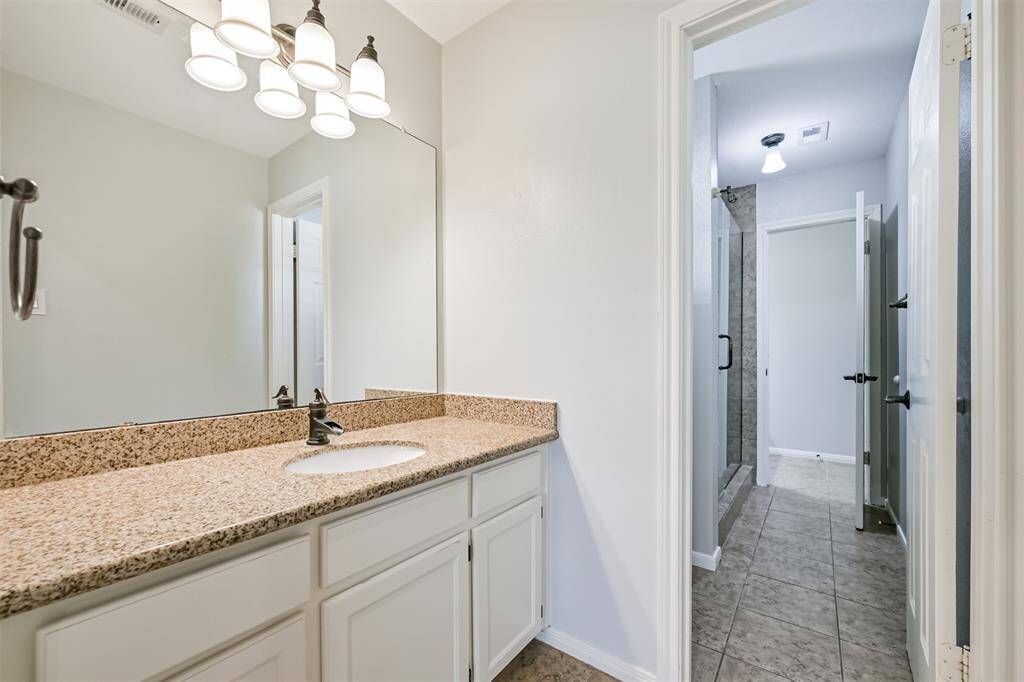 BEAUTIFULLY UPDATEDBATHROOM WITH MODERNFIXTURES, AND A WALK-INSHOWER.