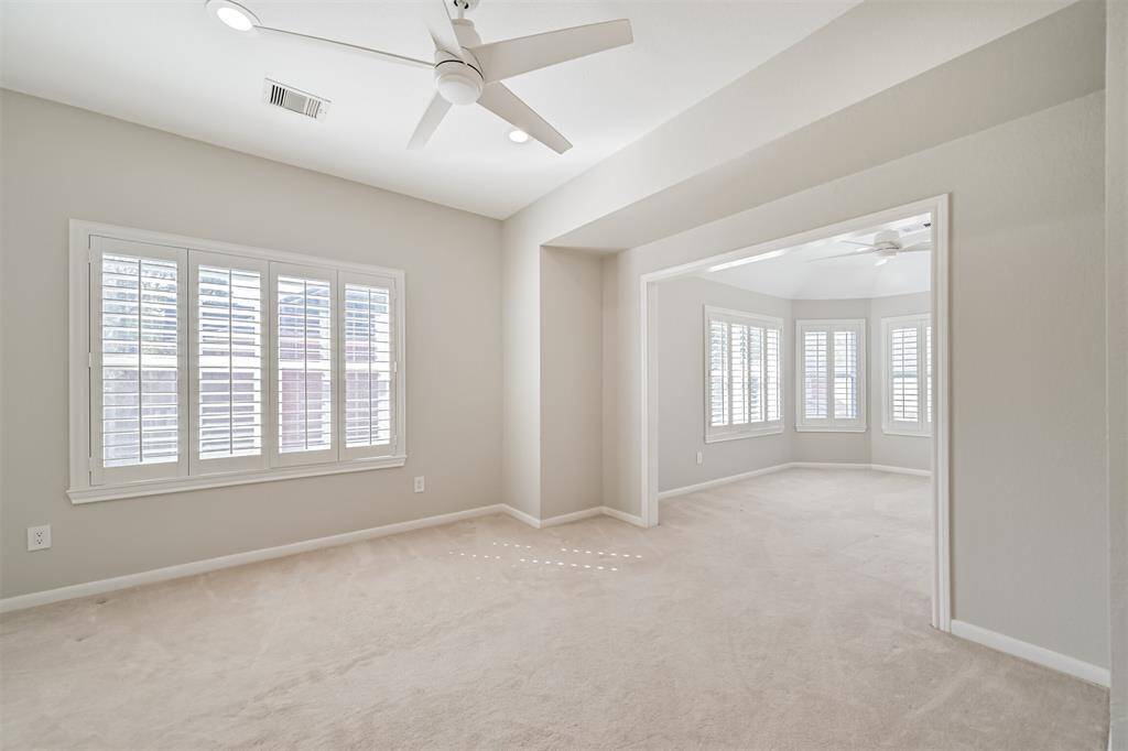 LIGHT-FILLED OVERSIZEDBEDROOM WITH PLANTATIONSHUTTERS AND ACONNECTING SITTING AREA