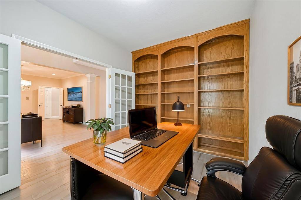 ELEGANT HOME OFFICE WITHBUILT-IN BOOKSHELVES ANDFRENCH DOORS FOR PRIVACY.***Room has been virtually staged.