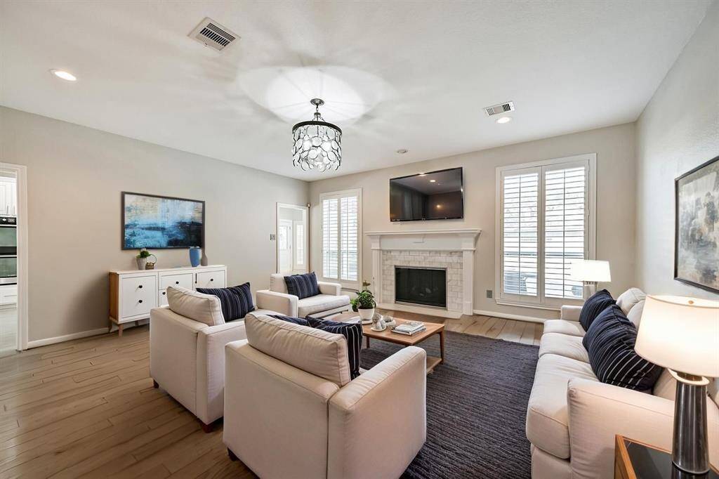 FAMILY ROOM WITH ADECORATIVE FIREPLACE,PLANTATION SHUTTERS, ANDSTUNNING LIGHT FIXTURE.***This room has been virtuallystaged.