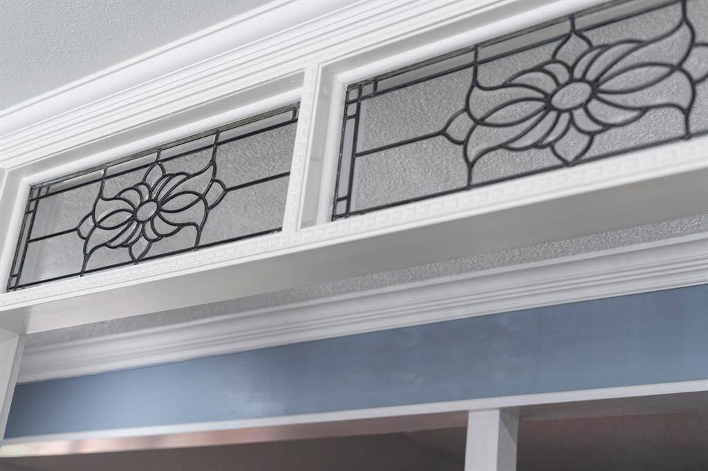 The leaded glass transoms in the kitchen lead to the living room.