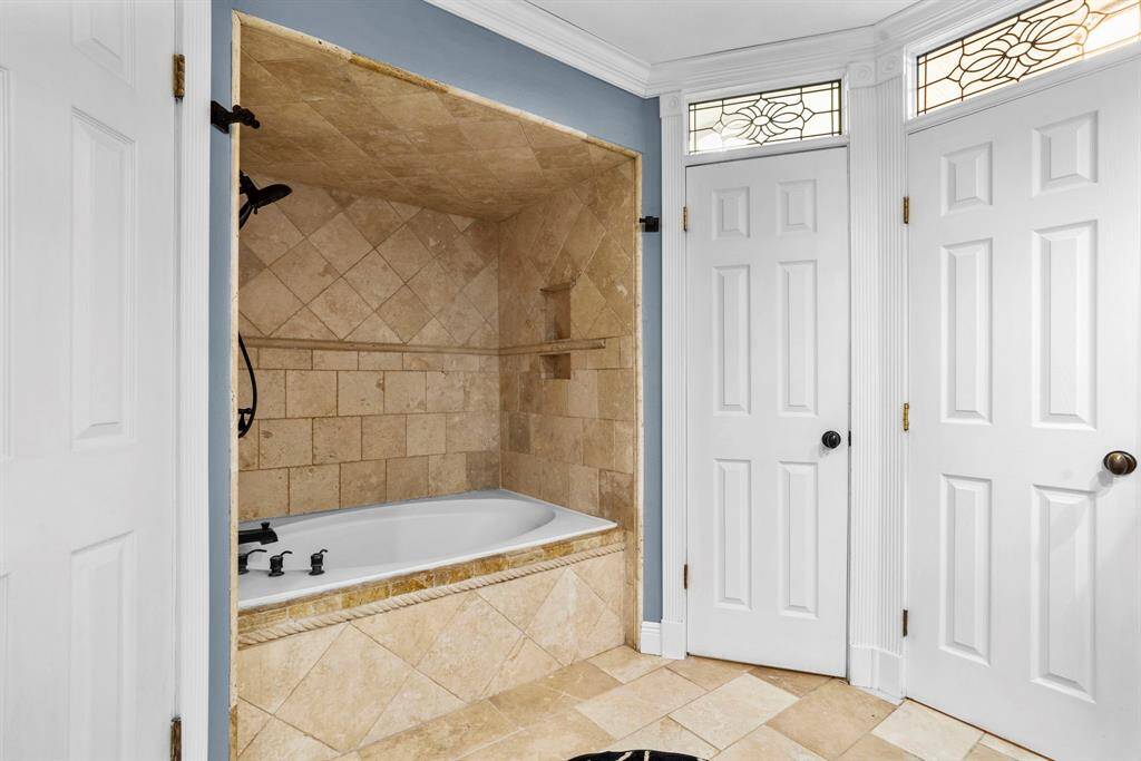 The tub and shower combo features tile surround.