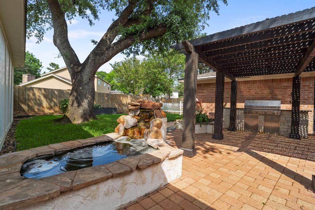 The backyard has a relaxing pond with waterfall!