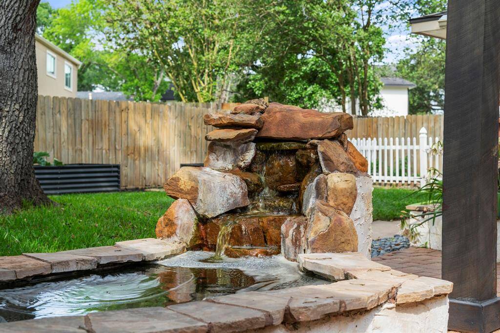 The backyard has a relaxing pond with waterfall!