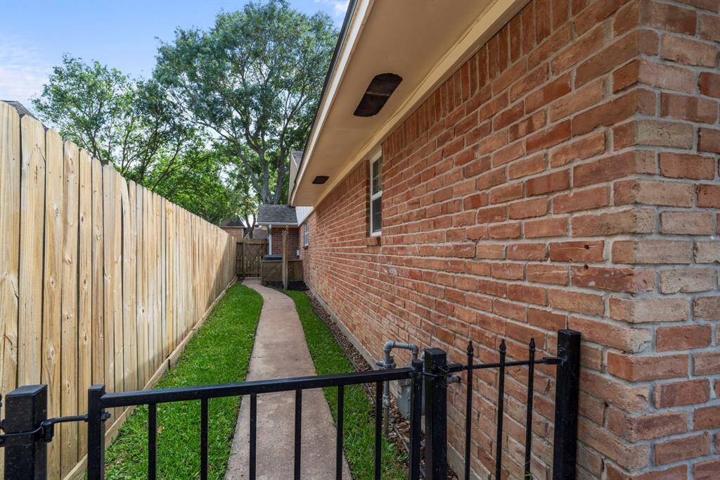 The side yard also has a paved walkway.