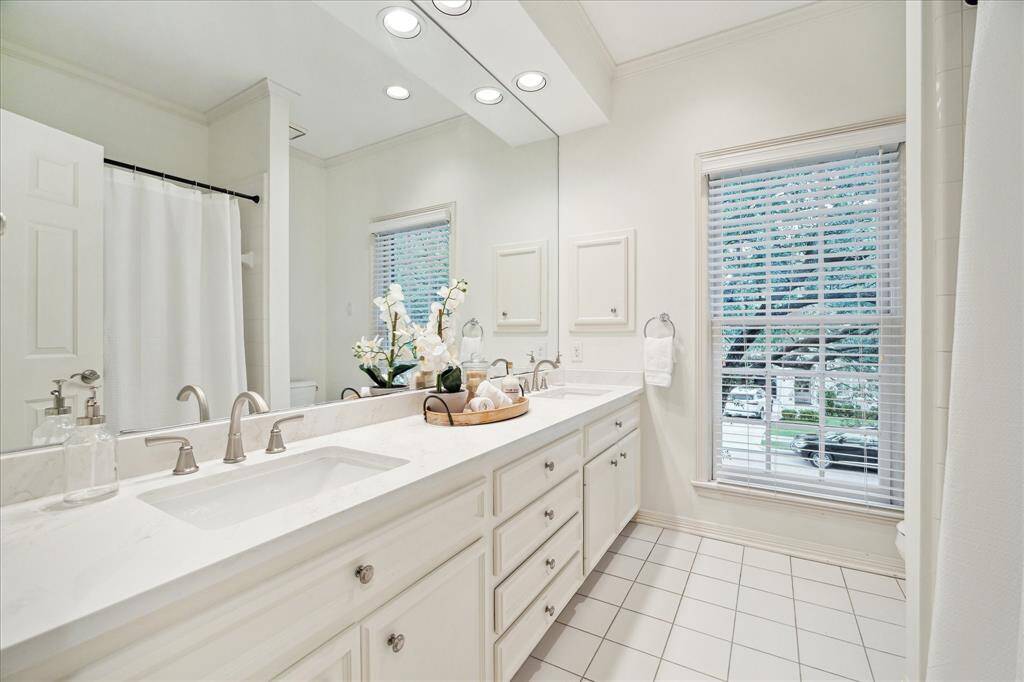 BATHROOM TWO.  Recently updated with quartz countertops and offers double sinks, tub/shower and private WC area.