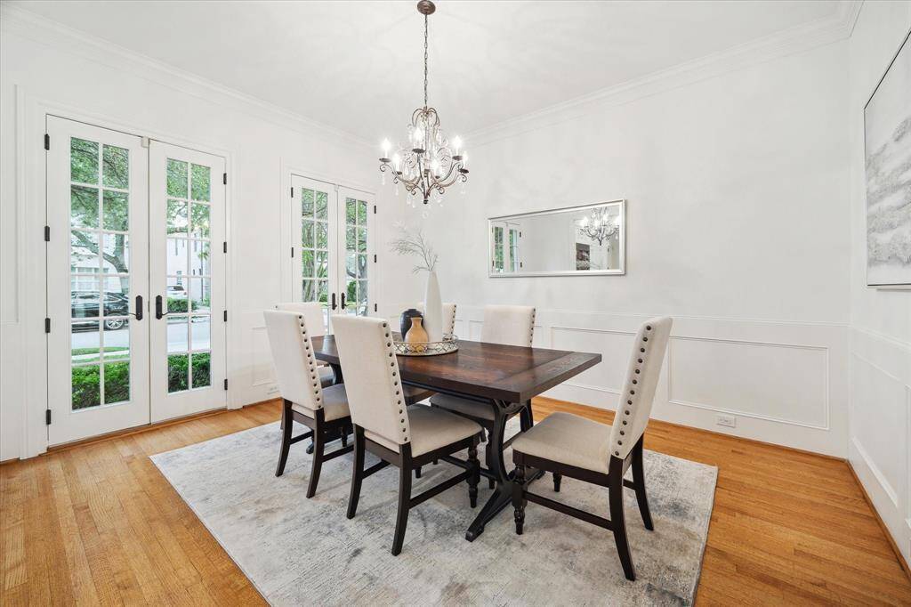 FORMAL DINING Adjacent from the formal living is this beautiful dining room with patio doors, wainscotting and an elegant light fixture. Swing door to the kitchen.