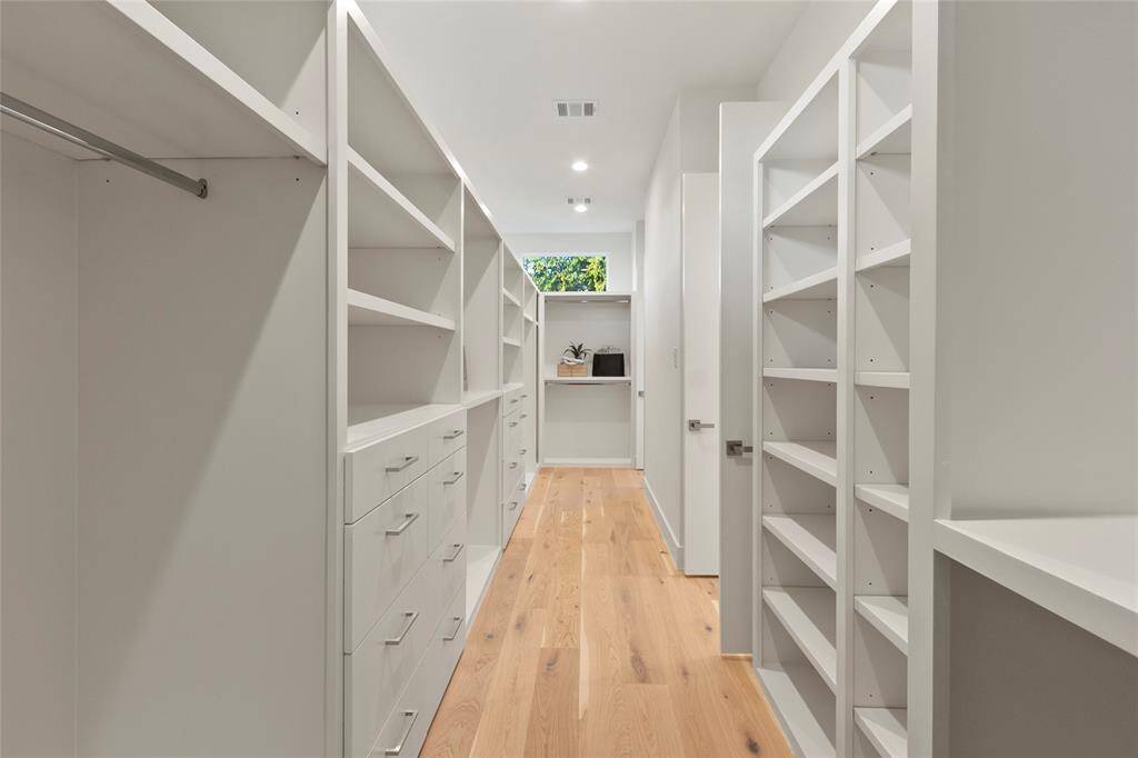 Huge primary custom bedroom closet with double entry fille
