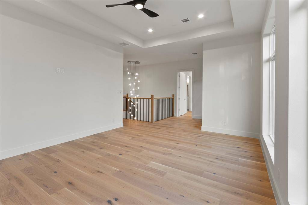 Game room upstairs with view of 2 story chandelier, pre wired for surround speakers