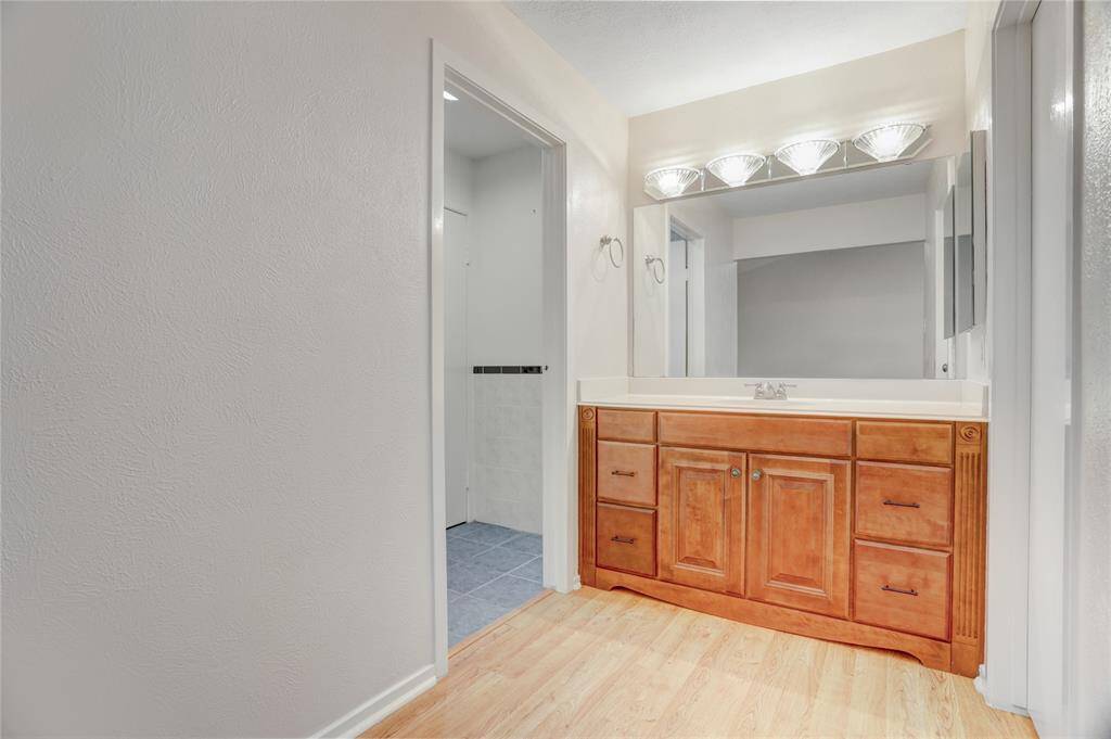 The sink and vanity area are separate from the rest of the bathroom for comfort.