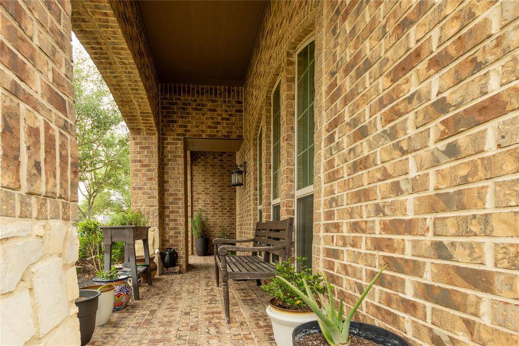 Covered porch with pavers.