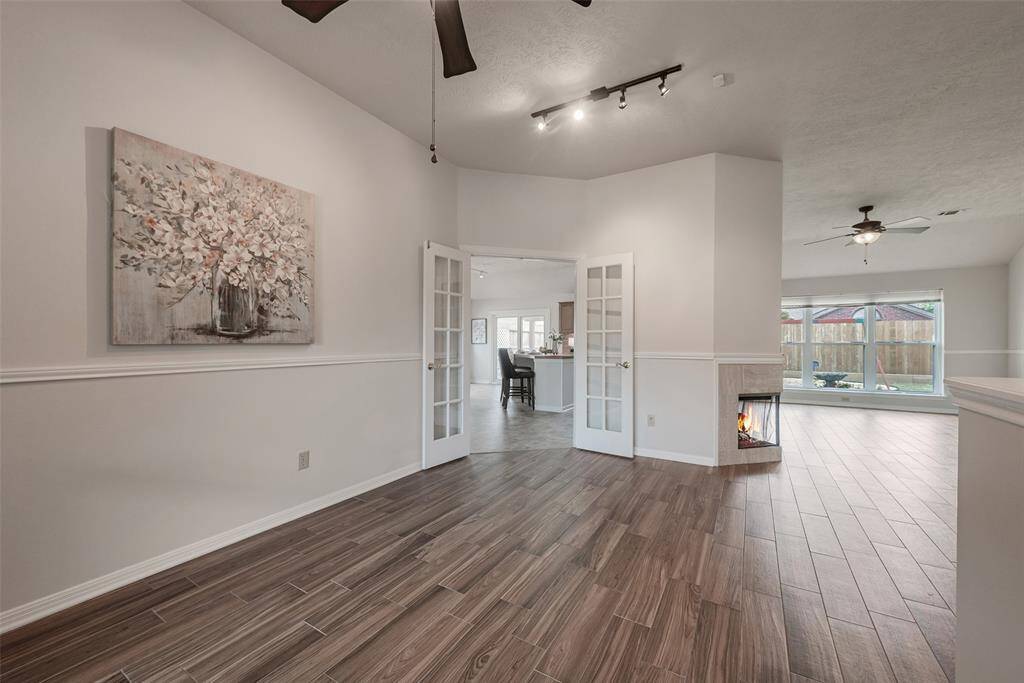 Attractive wood laminate flooring extends into the family room.