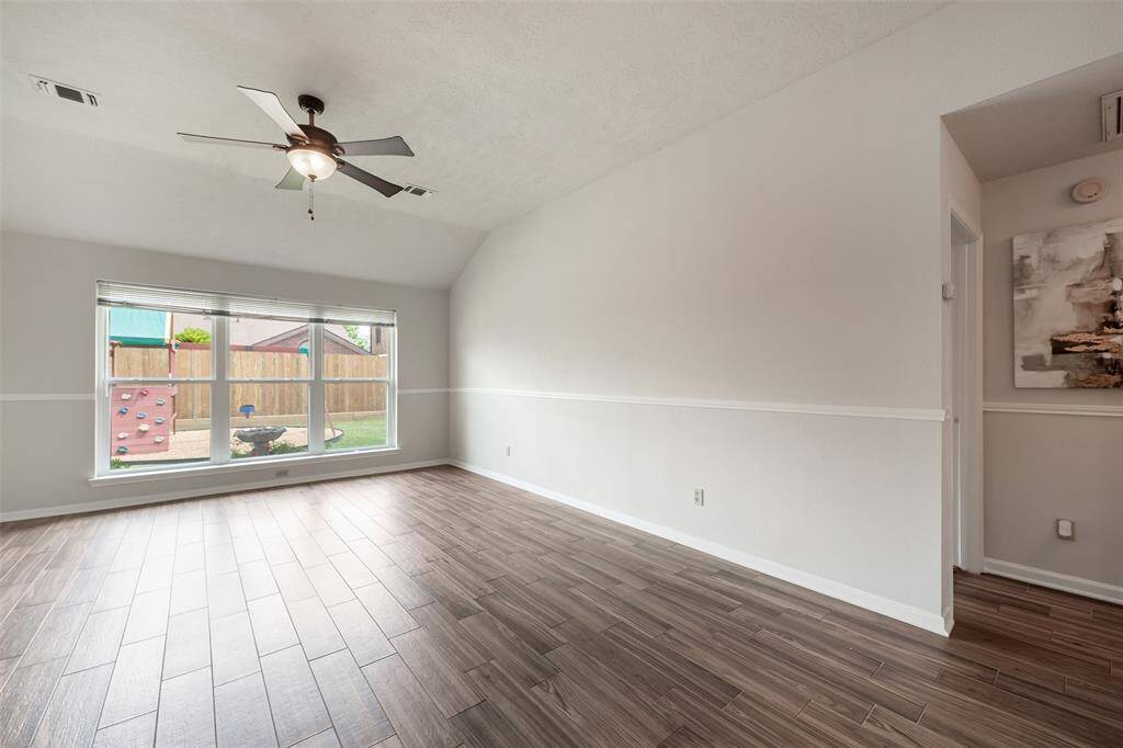 Wall of windows overlooking the backyard allow plenty of natural light when desired.