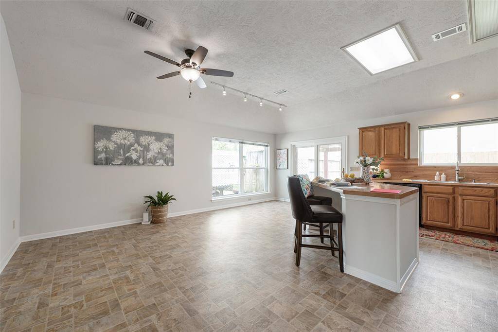 Spacious breakfast area with lighted ceiling fan.