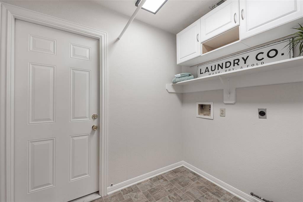 Indoor laundry room, cabinets and shelving.