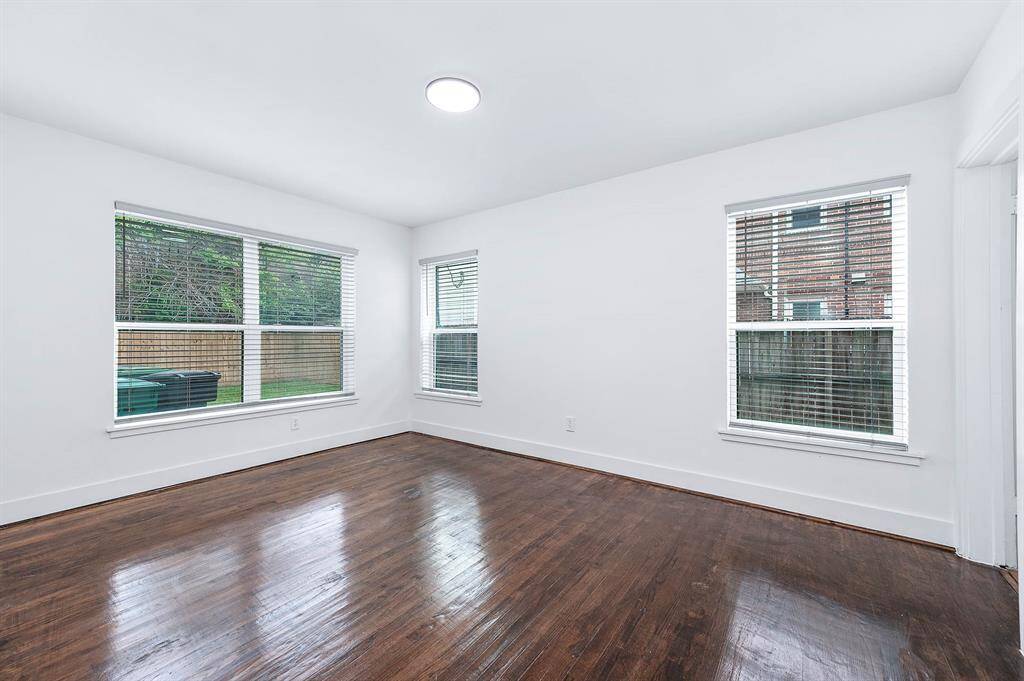 Bright and airy second bedroom with abundant natural light, offering convenient access to the hall bathroom