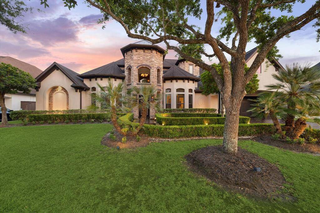 Welcome to your dream home—where astounding elegance collides with state-of-the-art technology and classic architecture. This stately residence boasts a striking stone turret entry with Mediterranean styled corbels, arched windows, and a picturesque creekfront location. Accented with uplighting and surrounded by lush greenery and palm trees, the home radiates curb appeal from every angle. A perfect first impression that sets the tone for the luxury within.