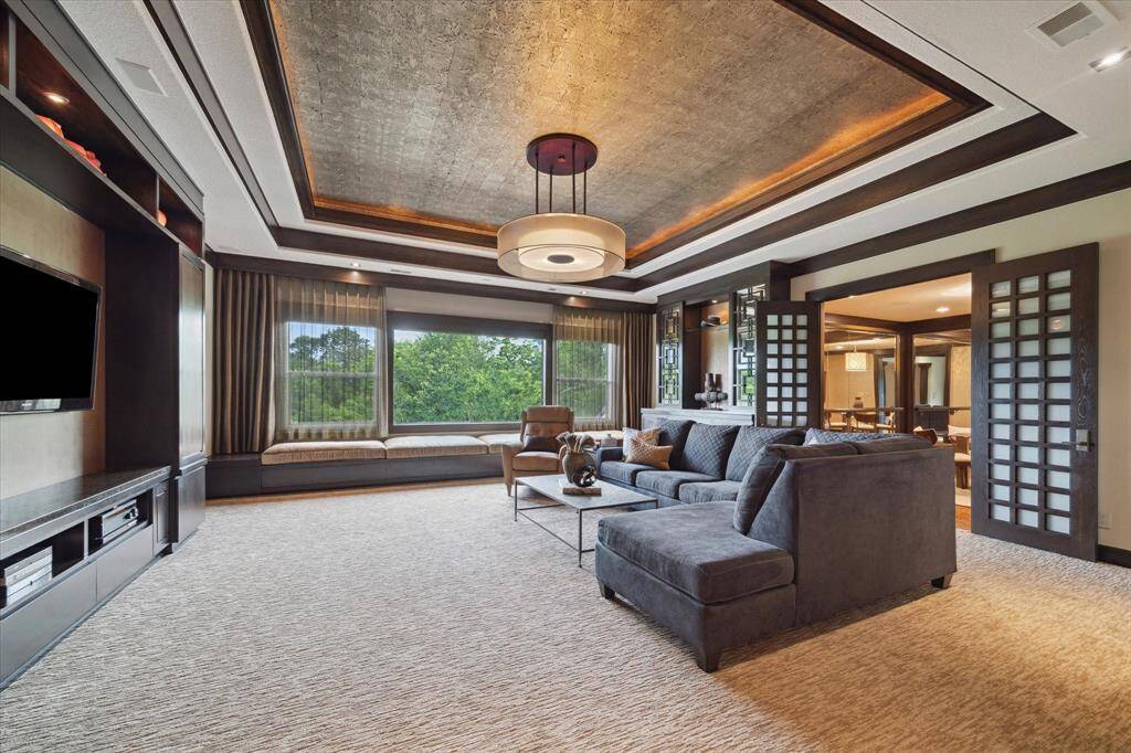 This refined second-level retreat seamlessly blends media lounge comfort with relaxation, featuring plush sculpted carpet and a spacious built-in window seat with hidden storage. Custom cabinetry flanks the game room and enhances both style and function, while the elevated floorplan offers a subtle sense of separation—perfect for a cozy, theater-like atmosphere. A conveniently connected full bathroom adds to the space’s effortless livability.
