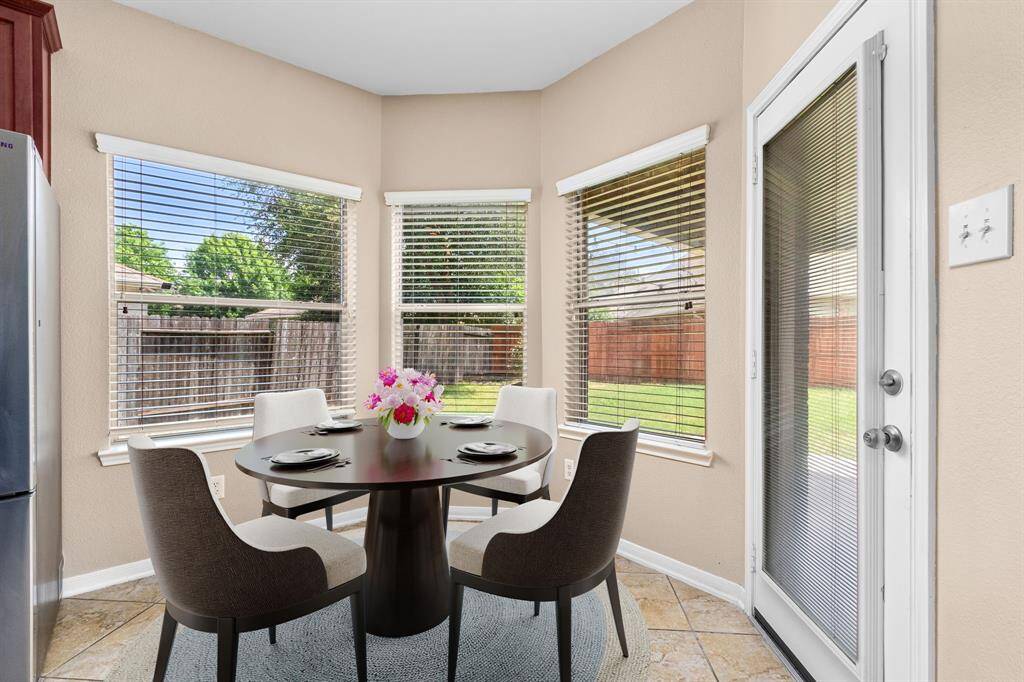 The breakfast room overlooks the backyard, with convenient access to the back patio for indoor-outdoor entertaining.