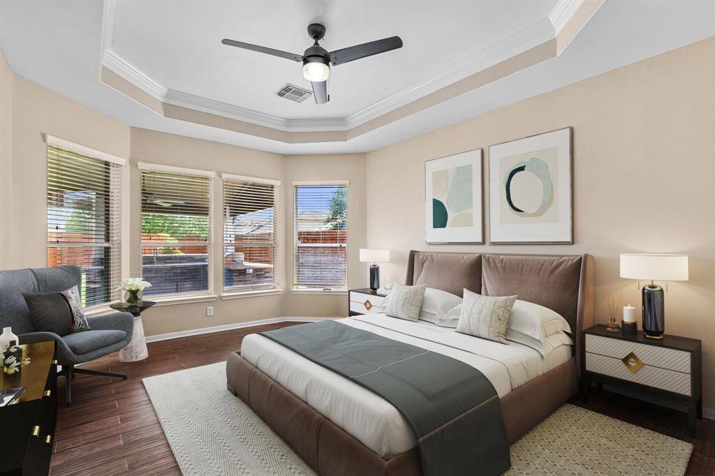 The spacious primary suite overlooks the backyard and benefits from a bay window and private lot location.