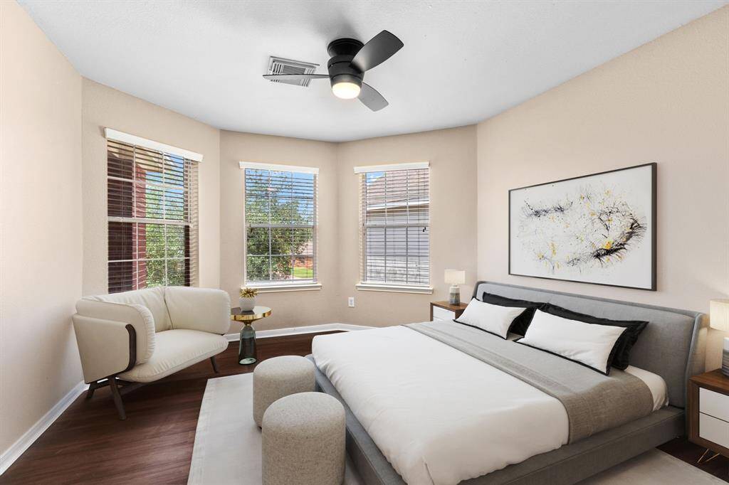Bedroom 2 features a bay window, filling this space with natural light when the blinds are opened and creating a cozy sitting area if desired.