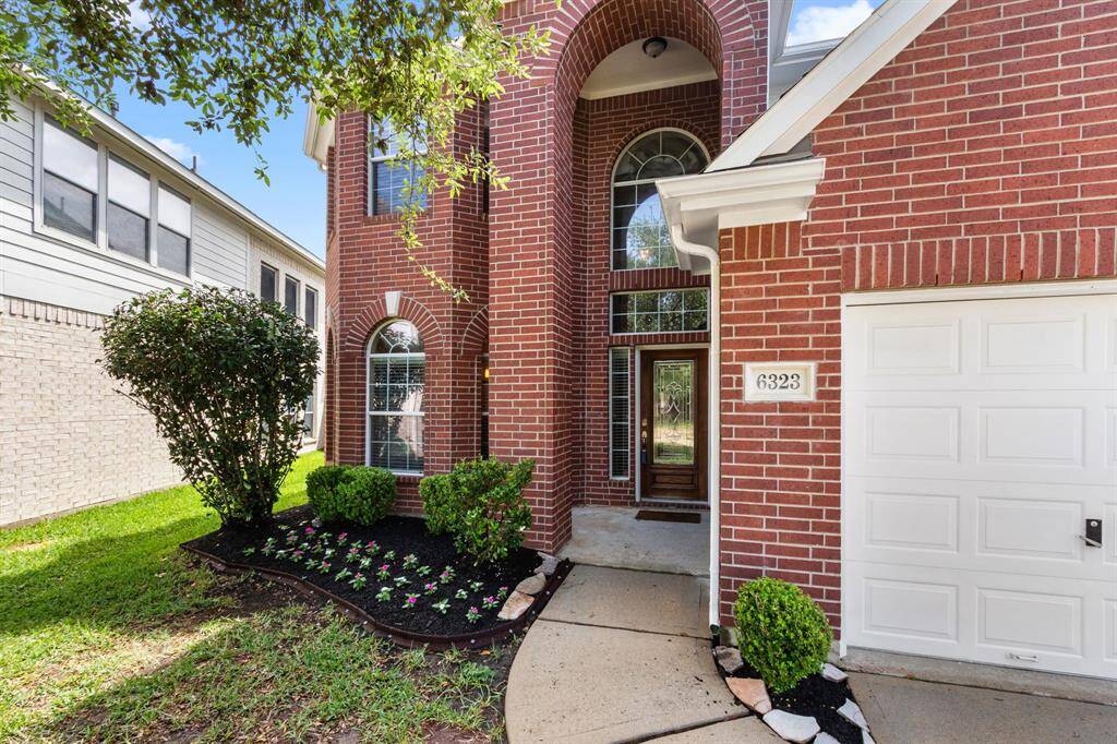 Mature landscaping and a covered front porch provide an ideal spot to welcome guests or receive deliveries in any kind of weather.