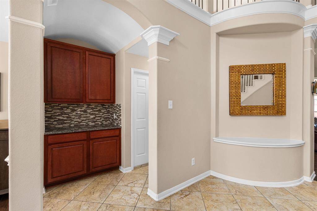 The butlers pantry seen to the left is a functional space for storing holiday serving platters, and could also be used as a family drop zone/charging station. Ideally located between the kitchen and dining room, this could also be the perfect appetizer/drinks station when hosting.