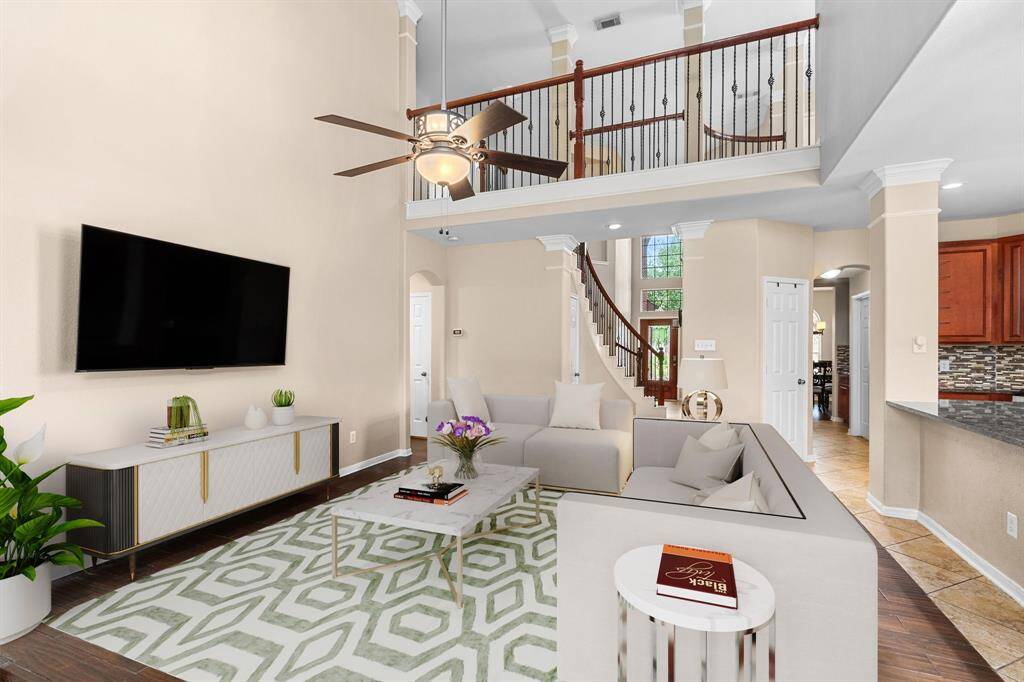 This rendering shows you the view from the living room to the entryway. The upstairs landing features the same wrought iron railing found on the staircase. The balanced mix of warm and cool tones and neutral color scheme will coordinate with any design style you prefer, from modern to traditional.