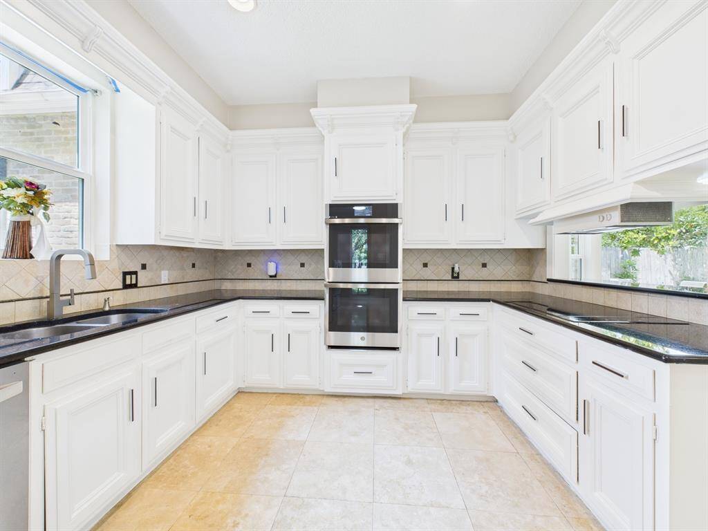 Sleek Black Countertops compliment the SS Appliances & Smart Double Oven