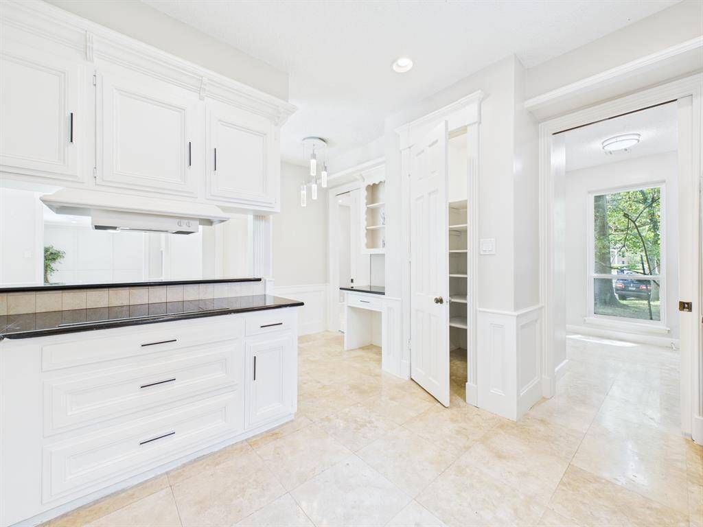 Electric Range Blends into the Countertops.  View of Pantry & Work Area with Adjacent Utility Room