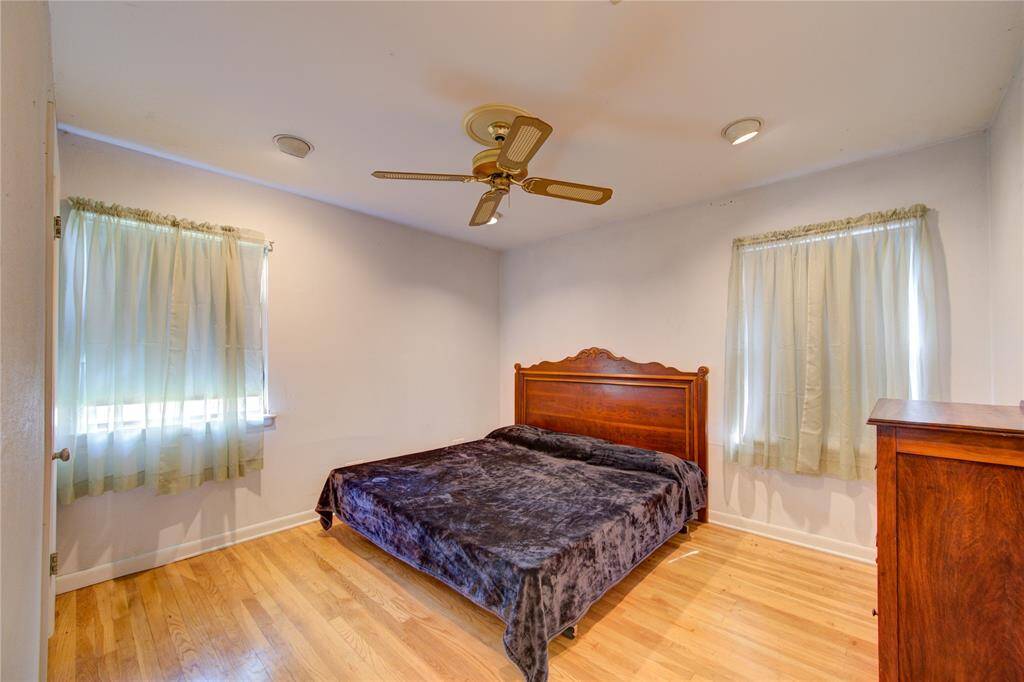 This generous bedroom offers ample space and natural light, perfect for relaxation and comfort.