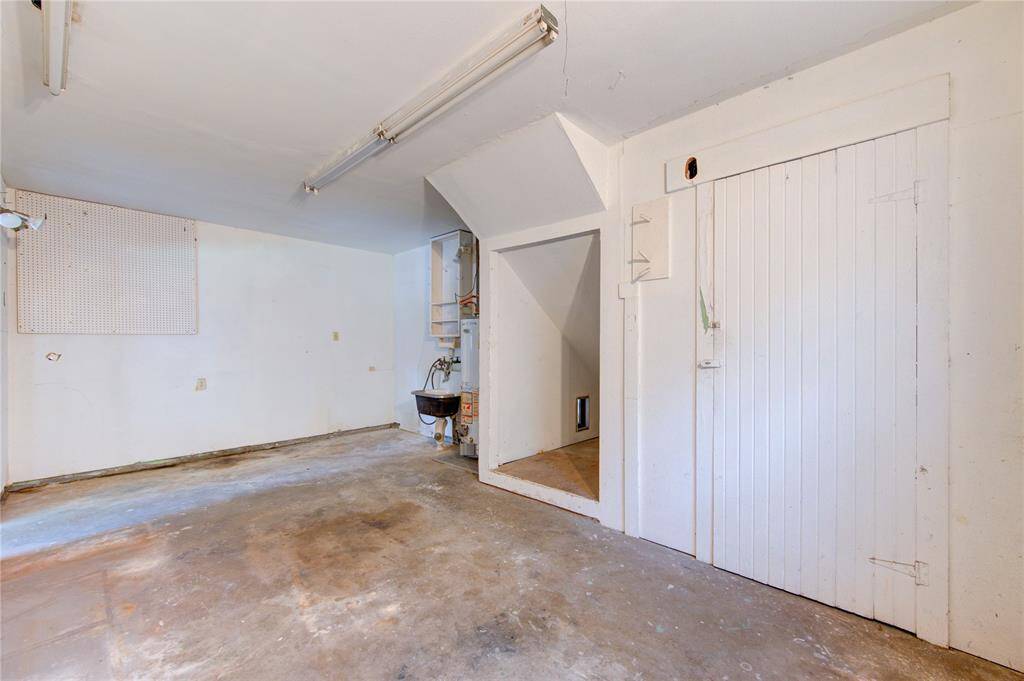 Spacious garage with ample storage, work sink, and natural light—ideal for projects and parking.