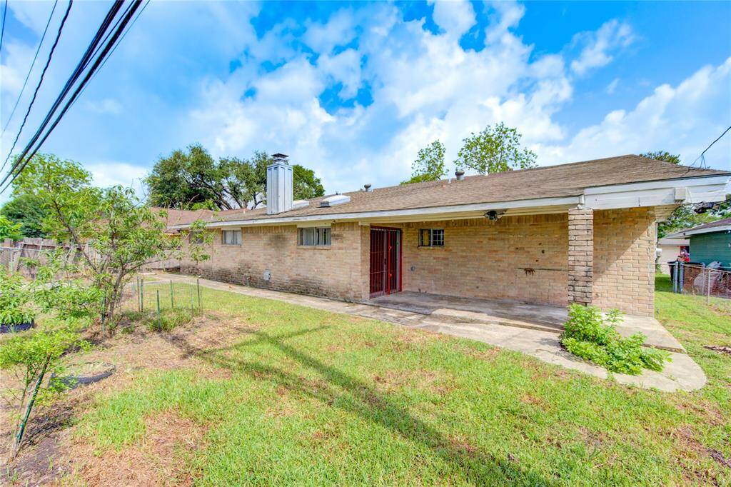 Charming backyard view with a spacious patio, perfect for outdoor relaxation and gatherings.