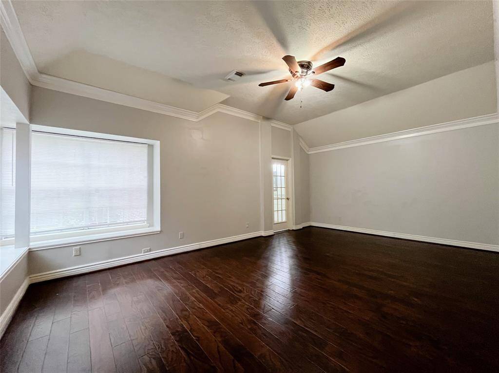 Spacious Primary Bedroom with a Vaulted Ceiling