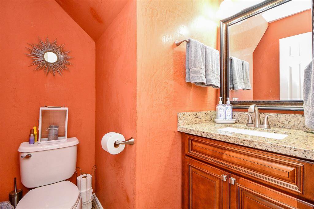 The downstairs half bath is conveniently located in the hallway.