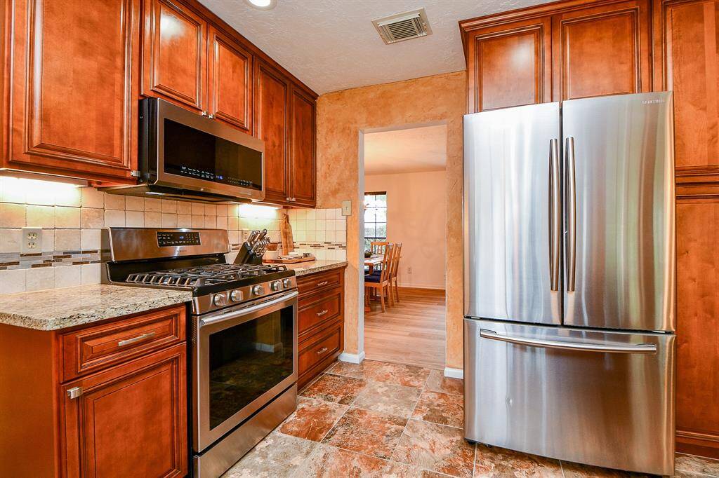 Another view of the beautiful kitchen that opens up into the formal dining room for easy dinner serving.