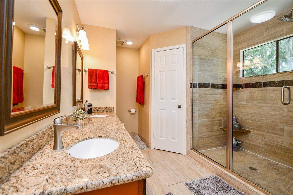 The primary bath has granite counters, double sinks and a supersized shower.