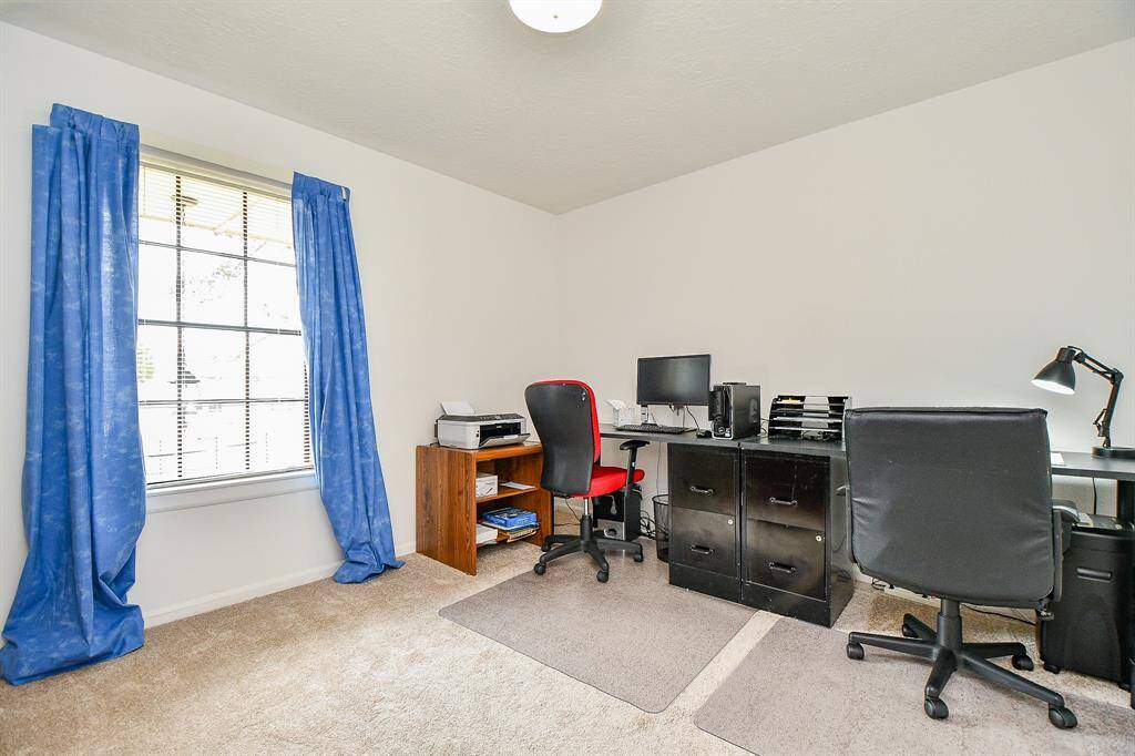 The connecting room is being used as a home office.