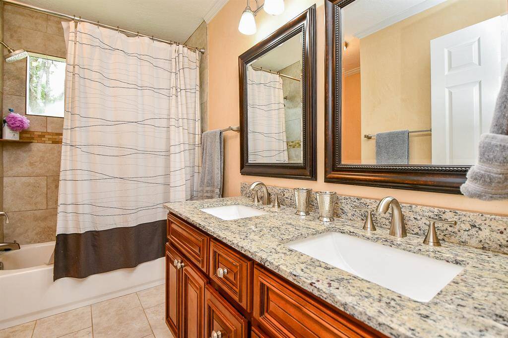 Upstairs guest bath features two sinks.