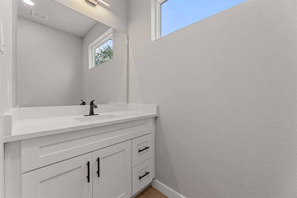 Downstairs half bath. Located just inside the front door, this guest bathroom offers convenience and privacy.