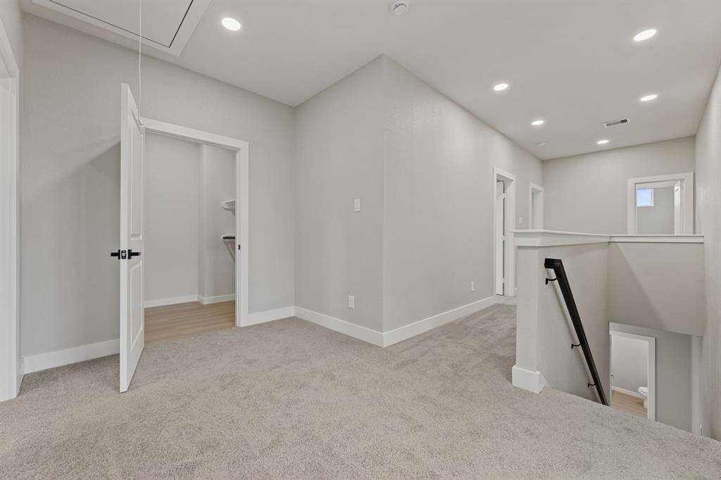 Welcome to the top of the stairs—where convenience meets comfort. This spacious landing leads to the utility room and primary suite, offering easy access to your home’s essential spaces. With plenty of natural light and a well-designed layout, this area provides the perfect balance of function and style.