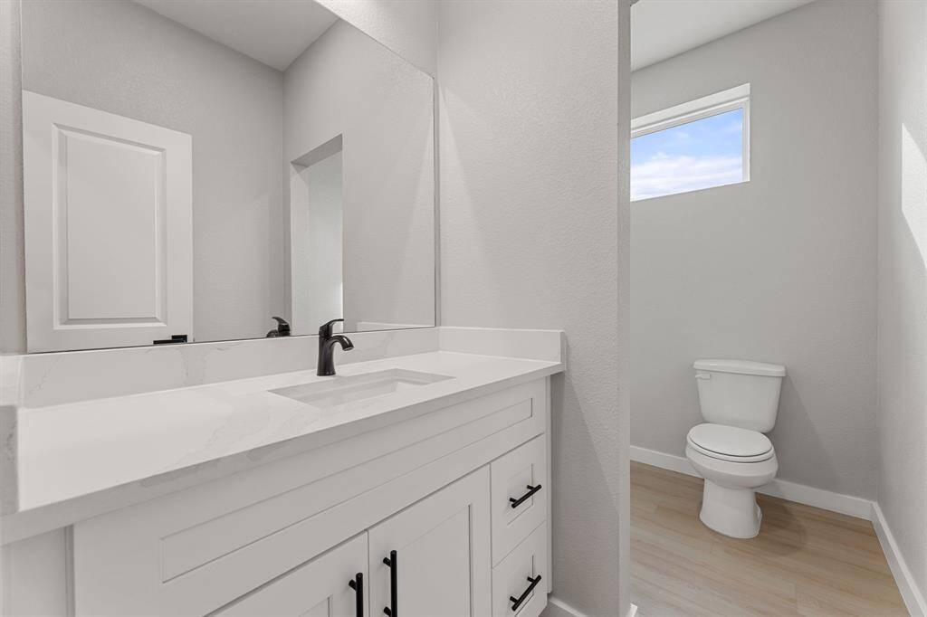 Upstairs full bathroom. The spacious bathroom offers quartz countertops, a large sink, and a shower/tub combo for ultimate convenience.