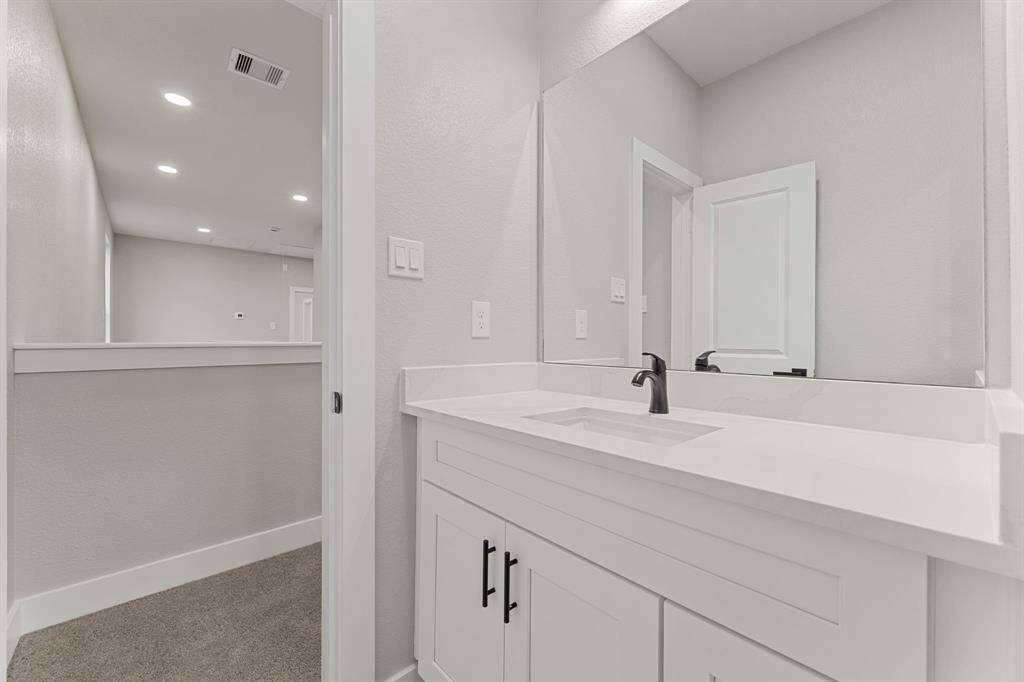 Bright and airy upstairs space. Featuring sleek quartz counters and ample space, this bathroom is perfect for the whole family.