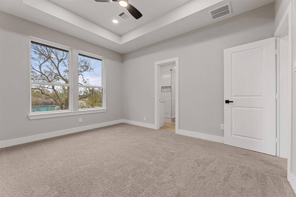 Relax after a long day. The primary bedroom offers a soothing retreat with plenty of natural light and high ceilings.