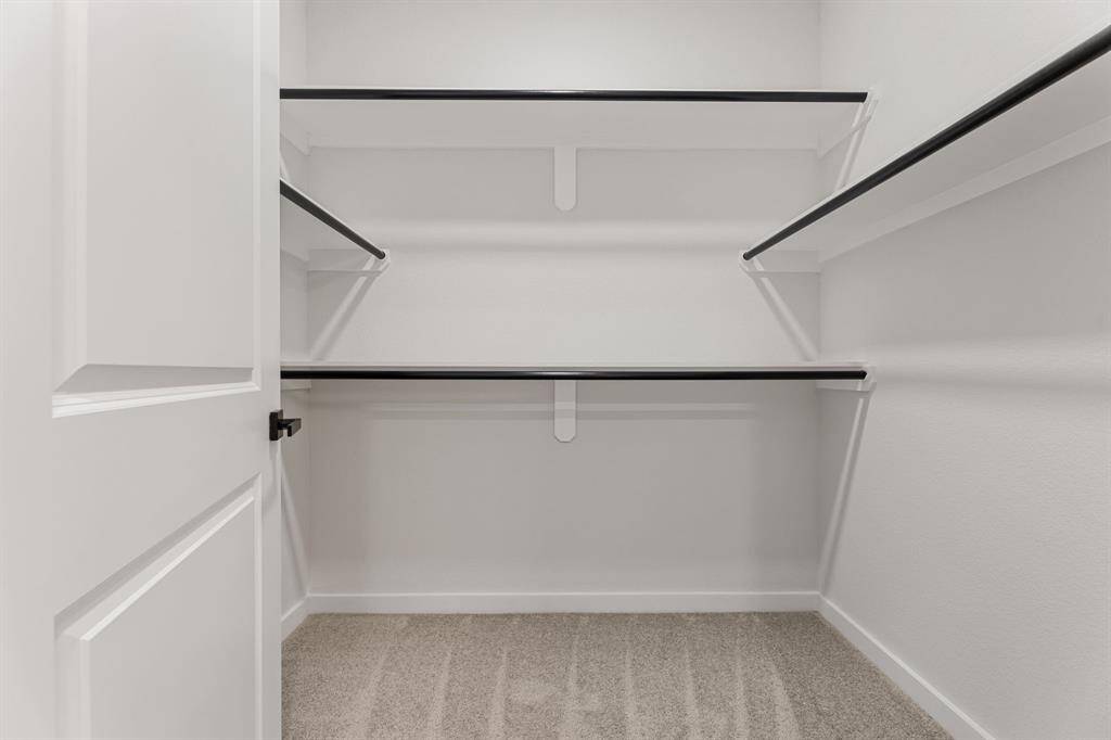 Designed with organization in mind. This spacious walk-in closet offers ample shelving and hanging space to keep your wardrobe neat and accessible. Perfect for those who appreciate both function and style, it’s a dream closet that makes everyday living easier.