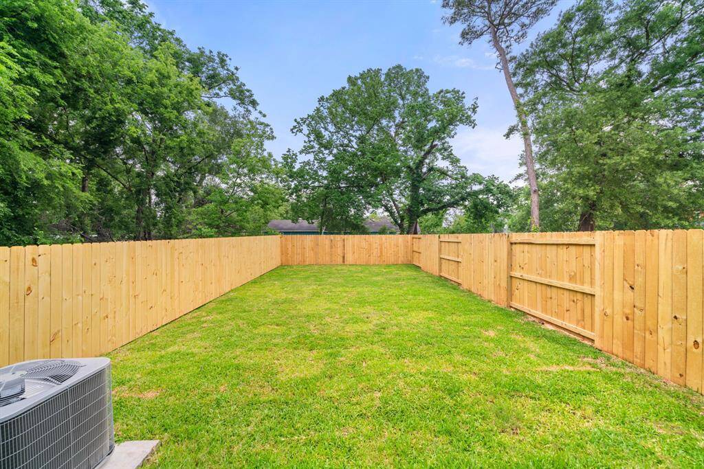 Outdoor living at its best! This generously sized backyard, with a new privacy fence, is perfect for hosting summer gatherings or enjoying a quiet evening under the stars.