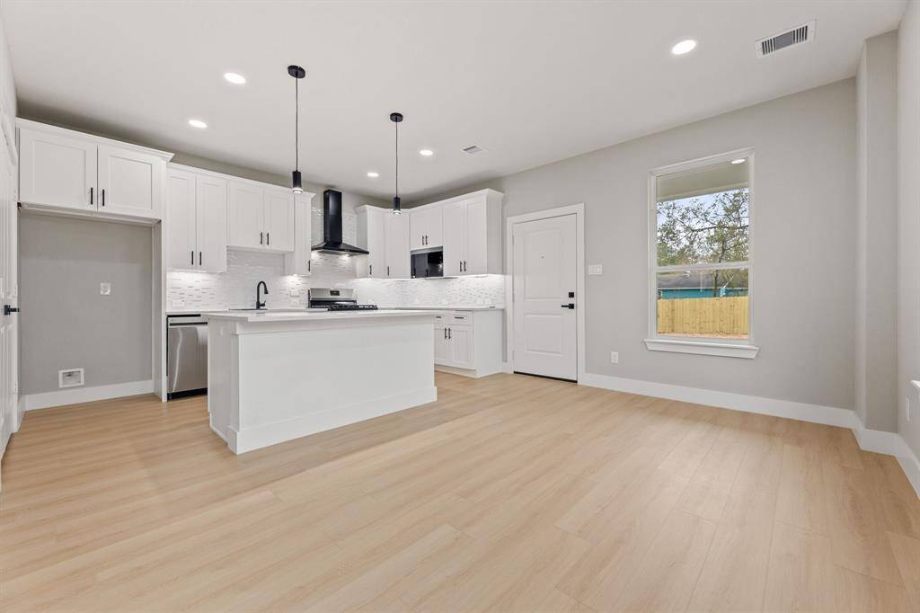 Connected living and dining. The open floor plan allows for easy flow from the kitchen to the living and dining areas, ideal for hosting guests.