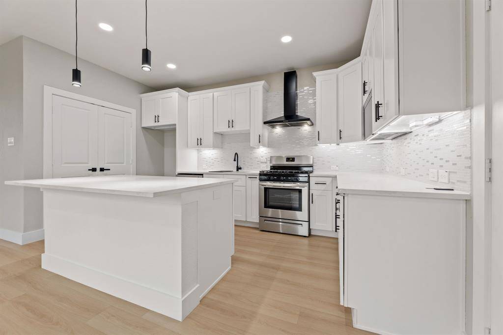 Chef’s dream kitchen. The large quartz island and high-end stainless steel appliances make this kitchen the heart of the home.