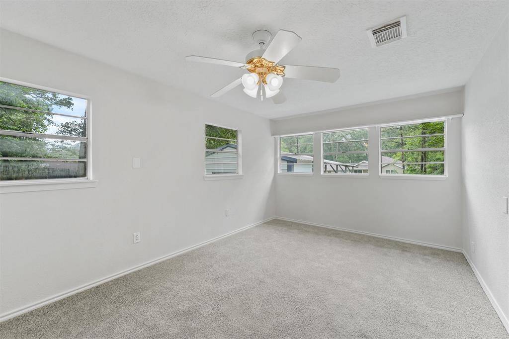 Cozy secondary bedroom featuring fresh, plush carpeting.