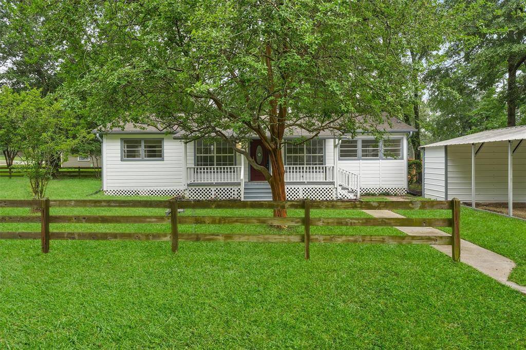 Charming home with lush, inviting front porch, and a quaint fence. Perfect blend of comfort and curb appeal. (virtually enhanced lawn)